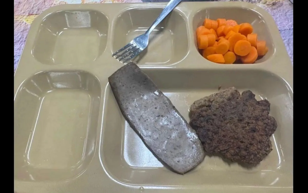 A photo of a near-empty tray with grey meat and boiled carrots, highlighting the unappetising meals served to Trump's troops, with a focus on the primary keyword of unappetising meals