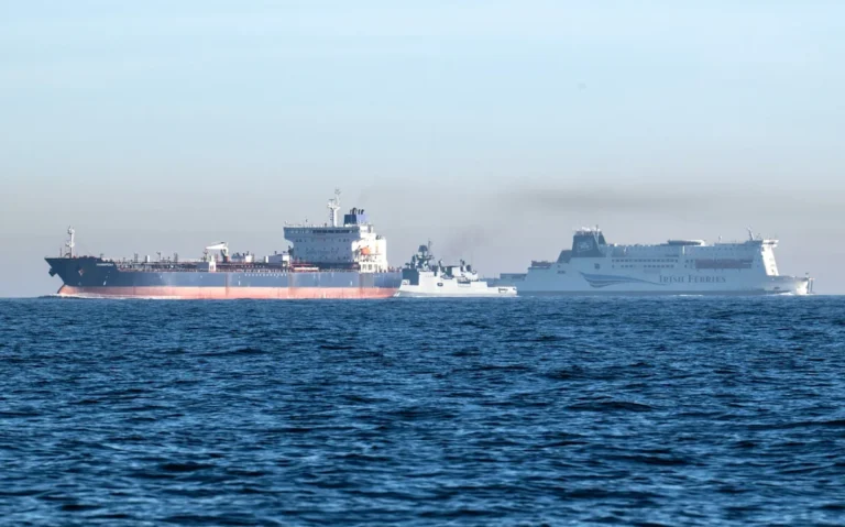 A photograph of a Russian ship in international waters, highlighting the complexity of seizing such vessels and the potential consequences for global relations, including the impact on the UK's economy and diplomatic standing, with a focus on Russian ships
