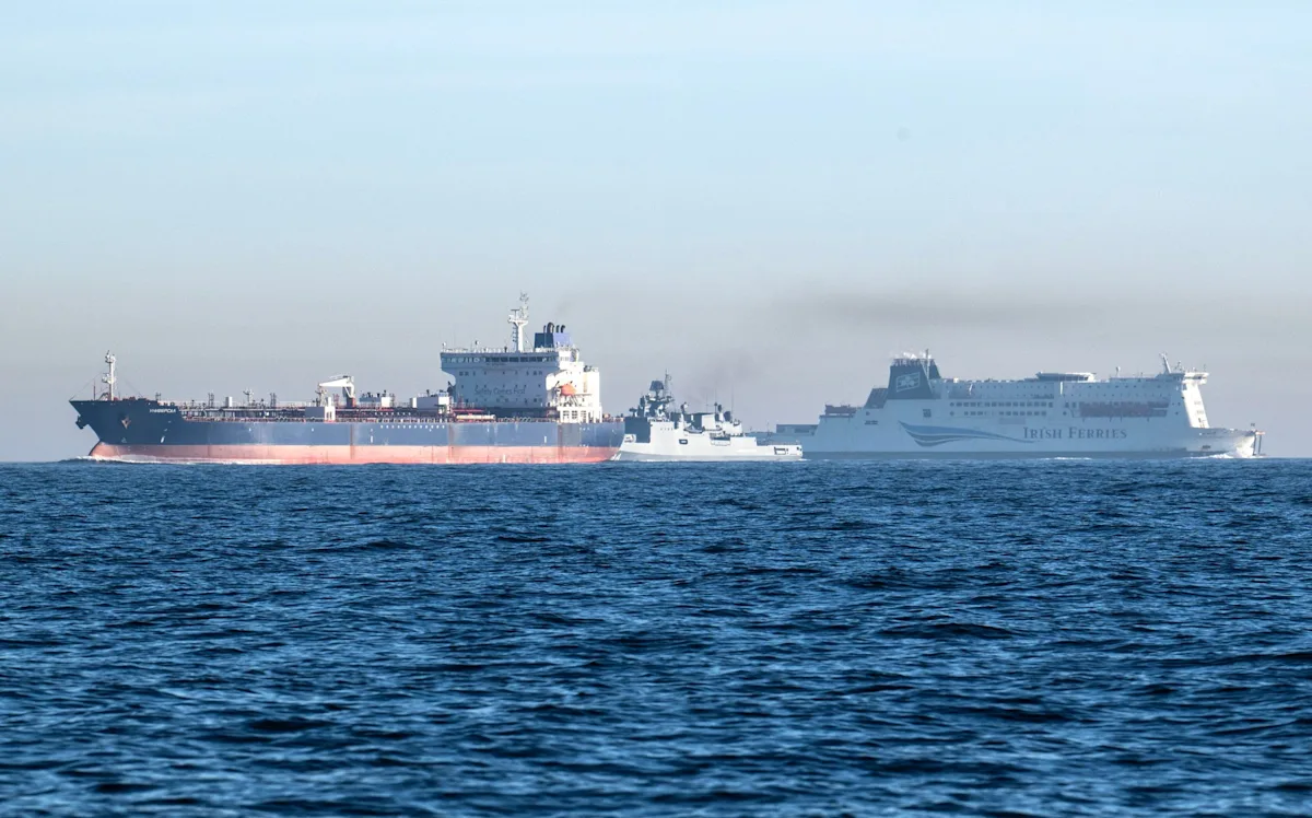 A photograph of a Russian ship in international waters, highlighting the complexity of seizing such vessels and the potential consequences for global relations, including the impact on the UK's economy and diplomatic standing, with a focus on Russian ships