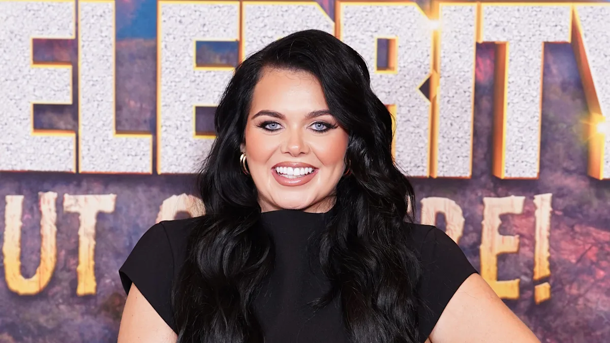 Scarlett Moffatt beaming with joy as she announces her pregnancy with her second child, a significant moment in her life as a celebrity and mother, with a bright colour scheme reflecting her happiness