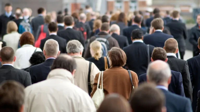 A graph showing the decline in unemployment rates in the UK, with a subtle background image of a person looking at a job board, highlighting the primary keyword of unemployment rates