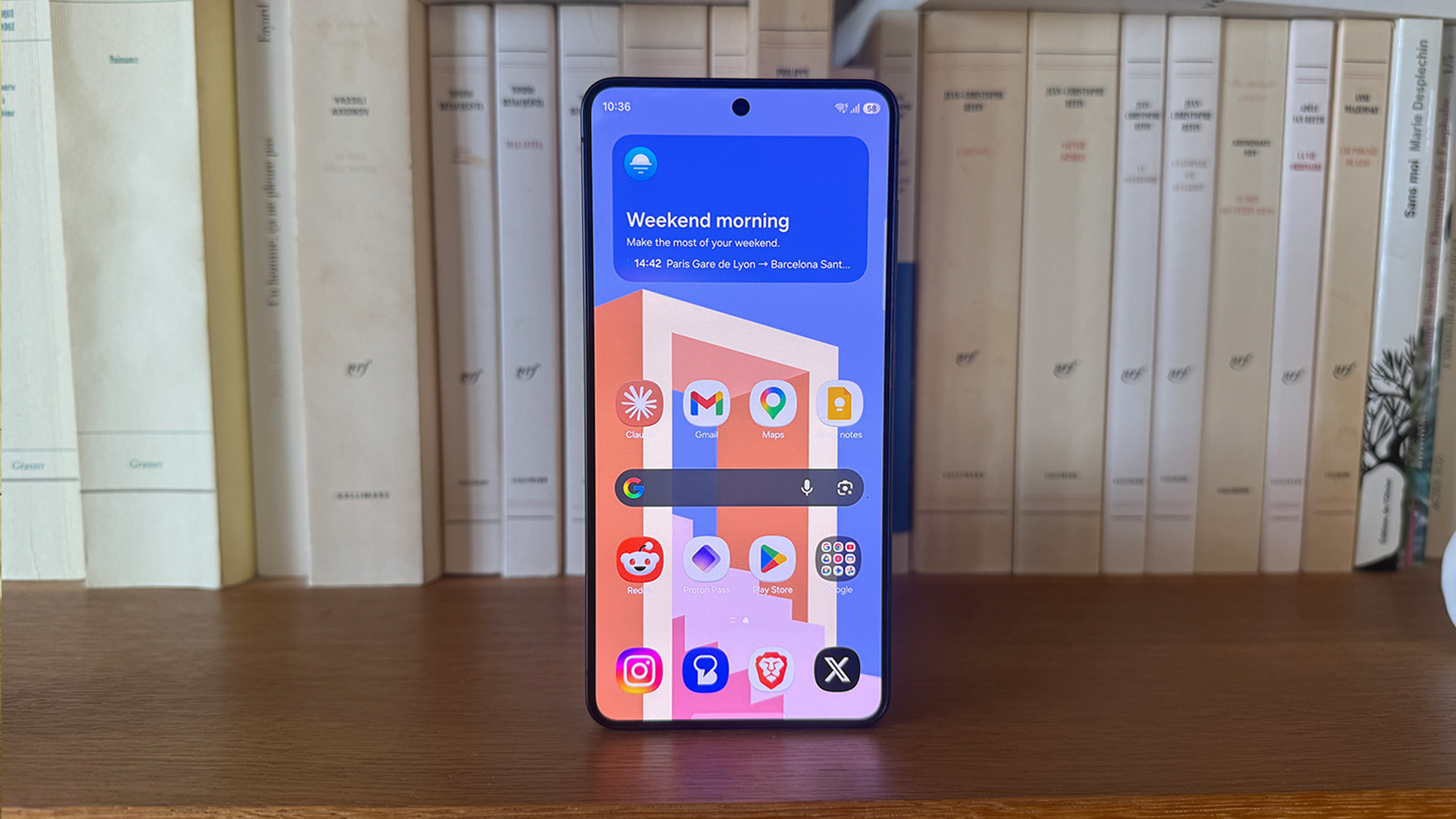 A person holding a smartphone with a cluttered home screen, surrounded by icons and apps, with a red circle and line through it, symbolising the need to clear out unused apps and improve cybersecurity