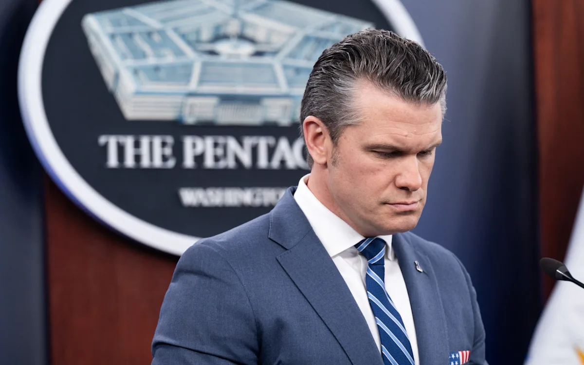 A dramatic image of the Pentagon building in Washington DC, with a subtle background of an Iranian flag, symbolising the tensions between the US and Iran, and the potential for war in the Middle East, with the primary keyword Iran war