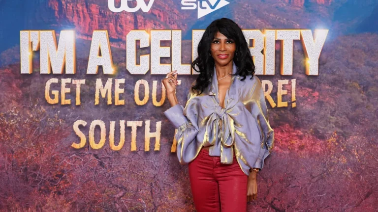 Sinitta looking shocked and shaken during the explosive I'm a Celebrity South Africa final, with a mix of colour and drama in the background, as she faces intense scrutiny over her behaviour