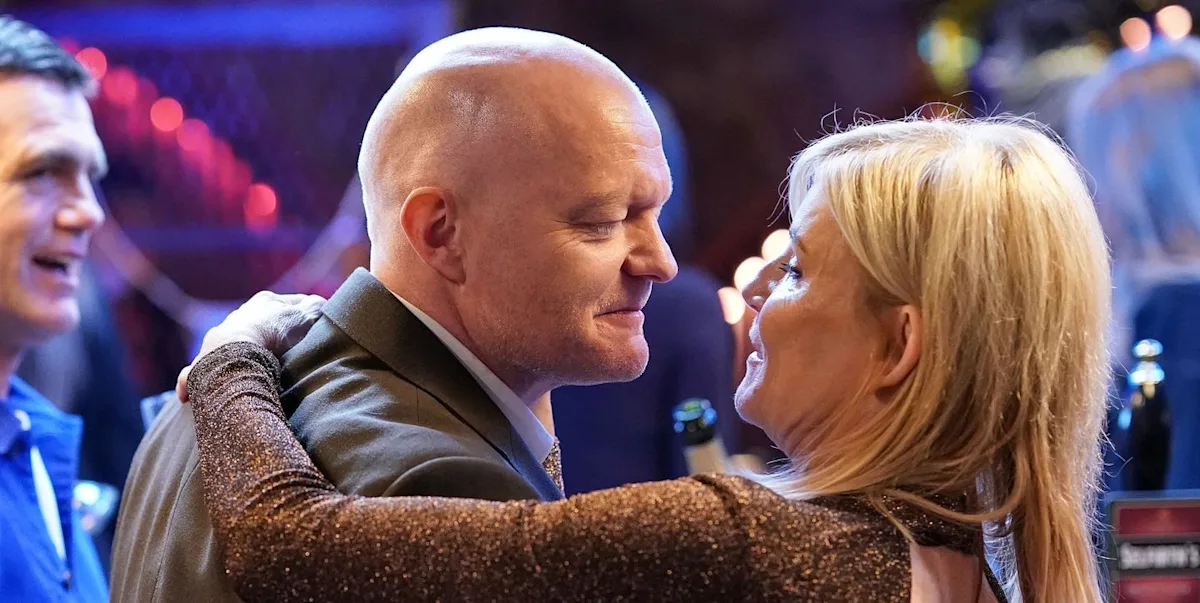 A dramatic scene from EastEnders featuring Max and Cindy, with a shocked expression on their faces, surrounded by a colourful and intricate background, highlighting the complex relationships and behaviour of the characters, with a focus on the primary keyword phrase 'EastEnders love triangle'