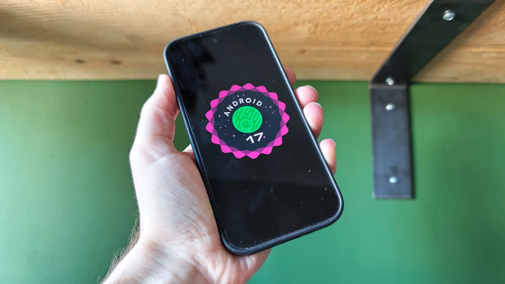 Android 17 logo on a smartphone screen with a UK background, featuring various smartphones from different manufacturers