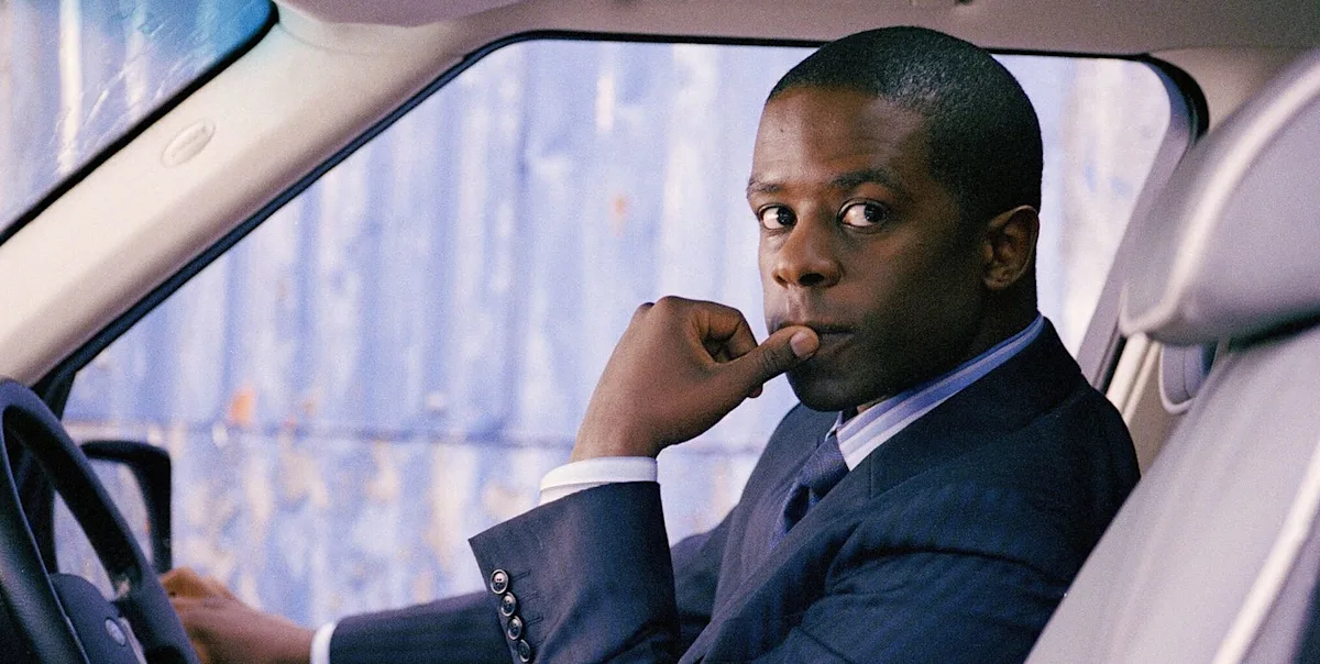 A dramatic scene from the BBC crime drama, with a detective analysing clues in a dark and moody room. The colour palette is dark and muted, with a focus on suspense and intrigue. The image captures the show's unique blend of suspense and drama, with a hint of what's to come in the new series.