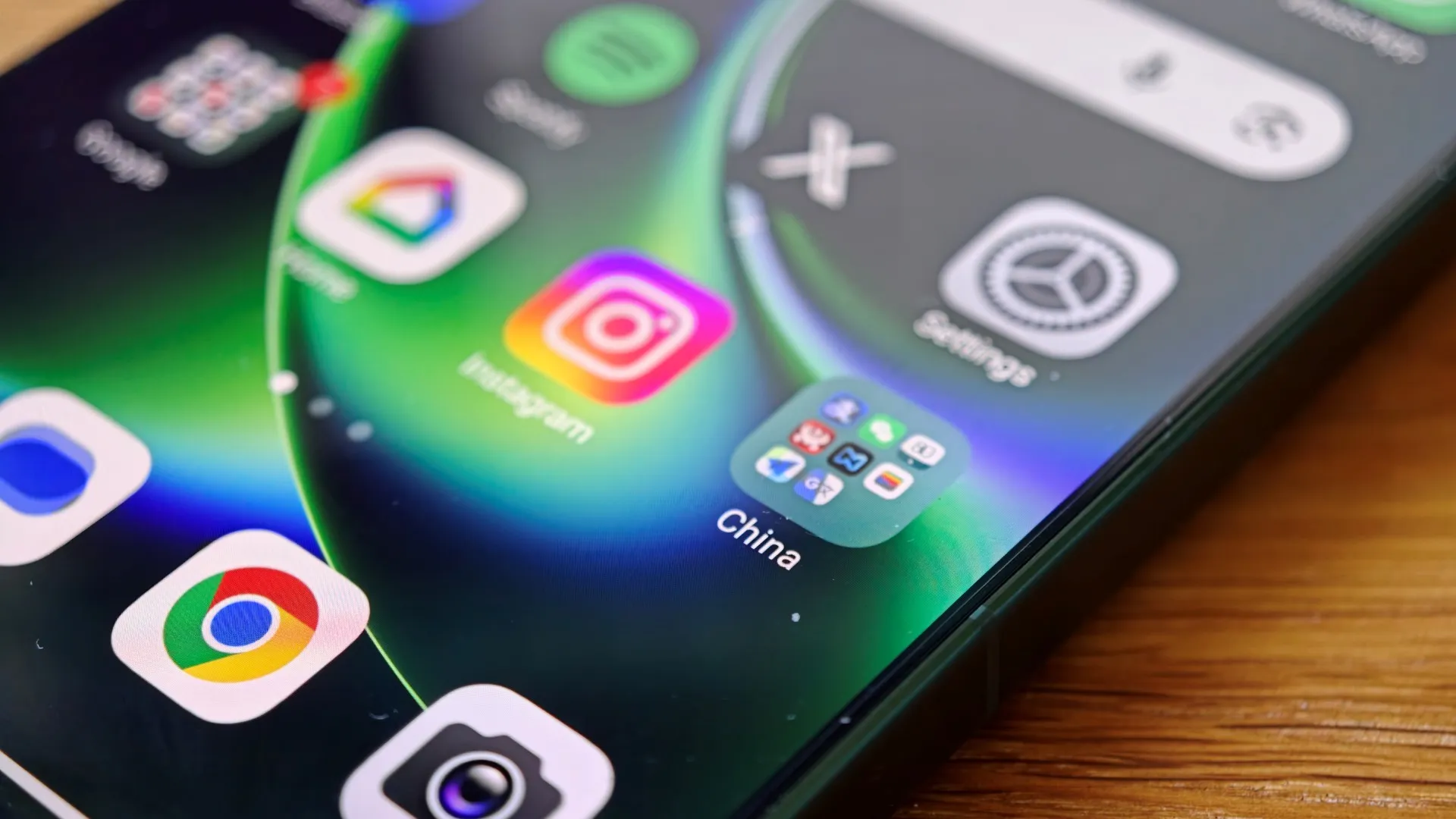 A person holding a smartphone with a map of China on the screen, with a blurred background of Chinese streets and buildings. The image represents the use of travel apps in China, with the primary keyword being China travel apps. The apps, including Amap, Alipay, and Nomad eSIM, are essential for UK travellers visiting China, providing a convenient and reliable way to navigate, make payments, and stay connected during their trip.