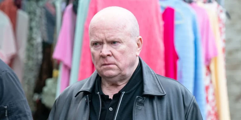 Phil Mitchell, a central character in EastEnders, stands outside the Queen Vic, looking concerned and unsure about his future, as he tries to come to terms with the death of Nigel and the impact it has on his life and relationships with others in Albert Square