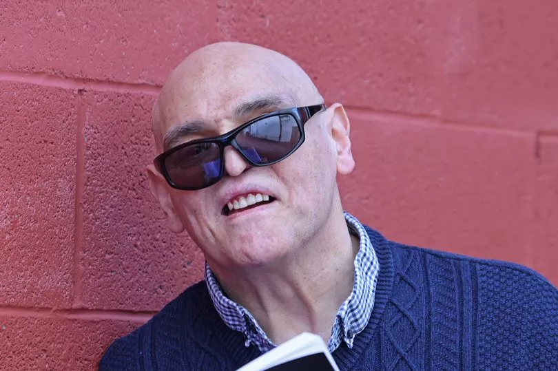 Mother holding photo of son lost to gun violence