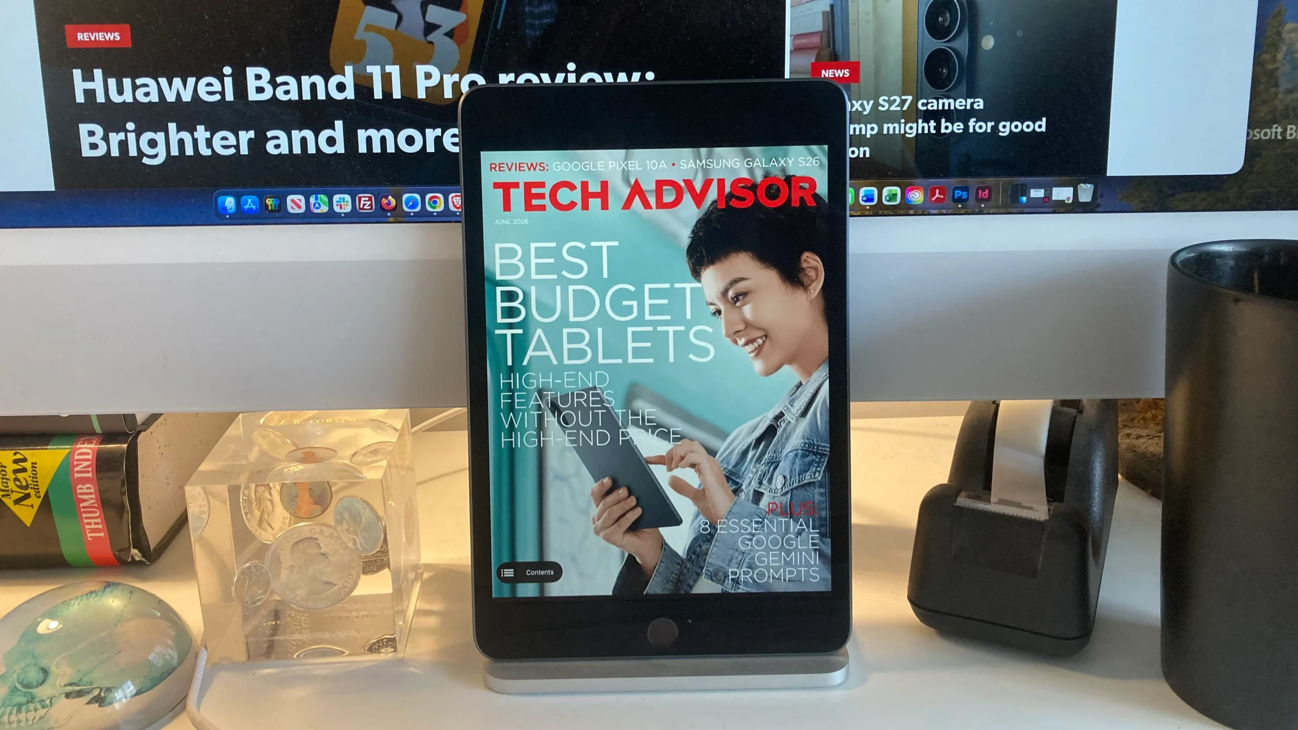 A person holding a tablet with a cityscape in the background, with a caption reading 'Stay productive on the go with the best budget tablets in the UK'