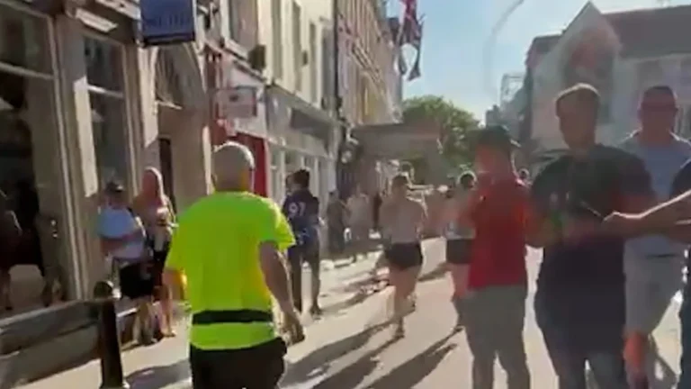 A disturbing image of a traveller whipping an elderly runner in a busy city centre, highlighting the need for community safety and addressing violent behaviour, with a focus on the primary keyword 'elderly runner'