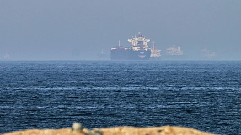 Aerial view of oil tankers navigating through the Strait of Hormuz, with the Arabian Sea in the background, symbolising the critical role of this waterway in international oil trade and the potential for increased oil production