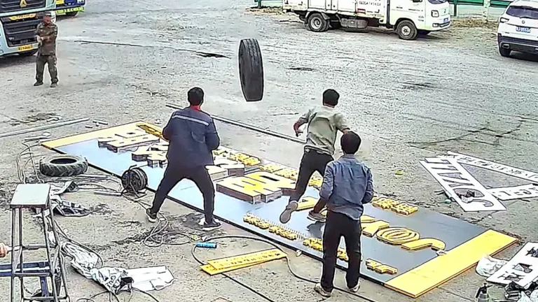 A runaway truck wheel hurtles towards workers in a near-miss incident, highlighting the importance of workplace safety and accident prevention, with a focus on safety measures and equipment maintenance to prevent such incidents