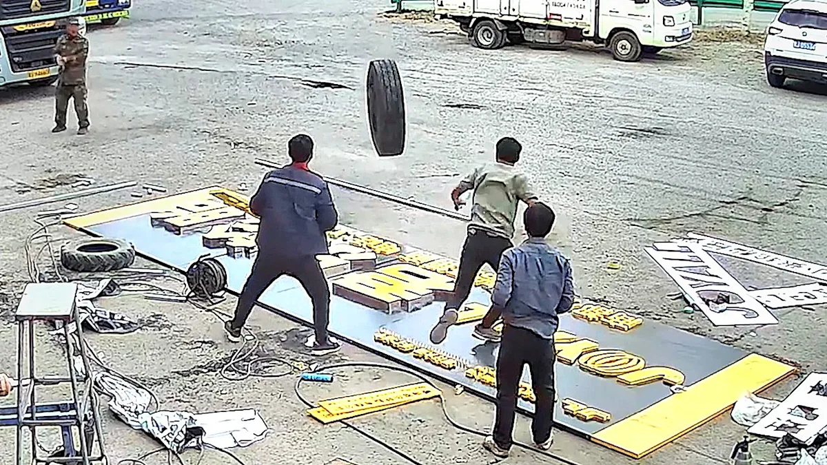 A runaway truck wheel hurtles towards workers in a near-miss incident, highlighting the importance of workplace safety and accident prevention, with a focus on safety measures and equipment maintenance to prevent such incidents