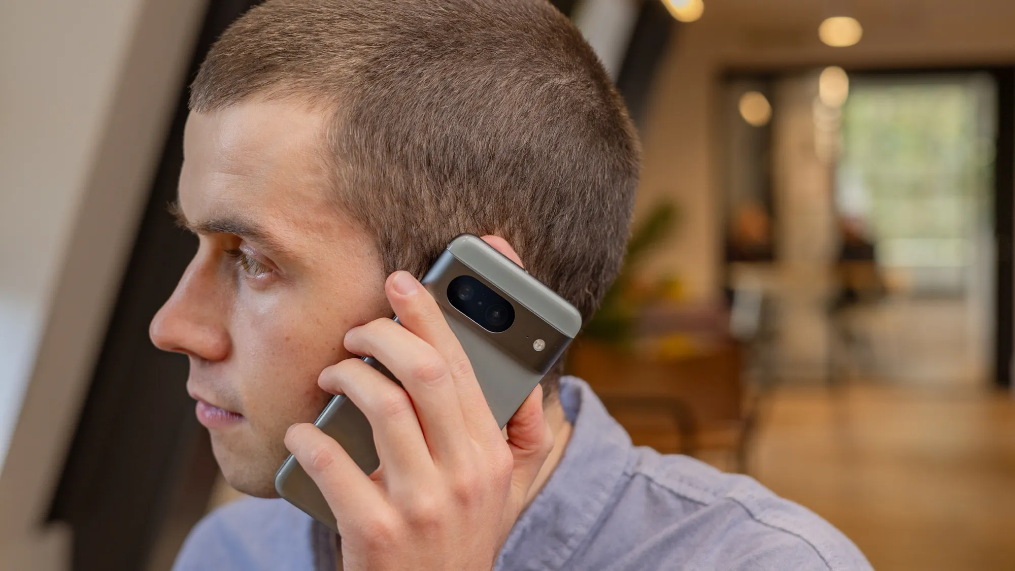 A person holding a Google Pixel phone with a frustrated expression, representing the eSIM issues affecting many UK users. The phone's screen displays a message indicating a loss of mobile network connectivity, highlighting the need for a solution to the eSIM problems.
