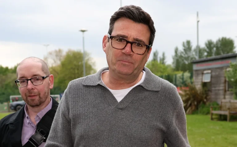 Andy Burnham speaking at a press conference, reassuring bond markets about his premiership and the economy, with a focus on leadership and stability, as he outlines his vision for the future