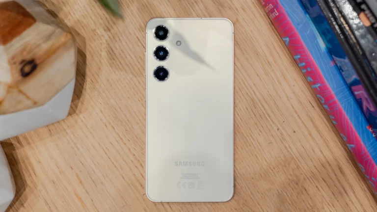 A Samsung Galaxy S24 device with a damaged battery, emitting smoke and flames, with a user in the background holding a fire extinguisher, highlighting the safety concerns surrounding the device's battery