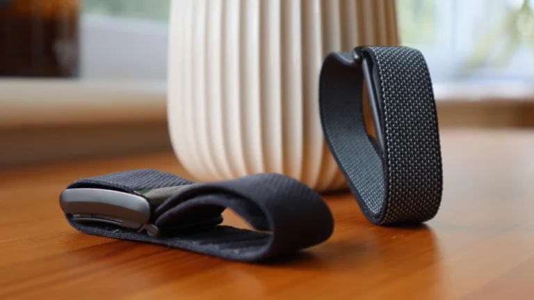 A person wearing a Fitbit Air and a Whoop Strap, with a cityscape in the background, highlighting the UK's fitness tracking scene and the primary keyword 'screenless fitness trackers'