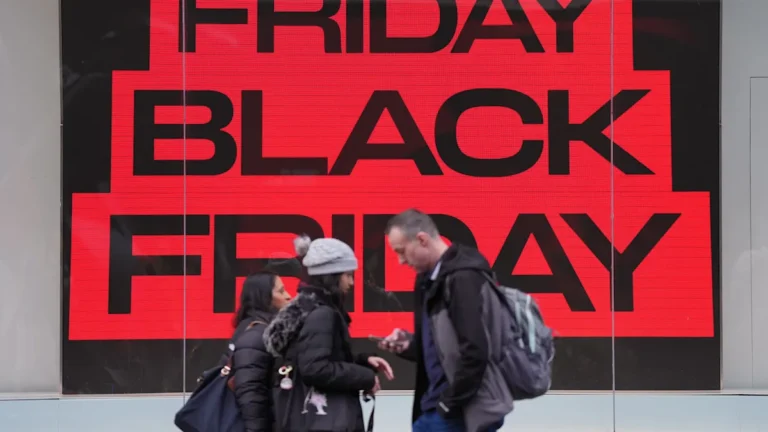 A person holding a tablet, looking at Black Friday deals on a website, with a disappointed expression, highlighting the primary keyword 'Black Friday'