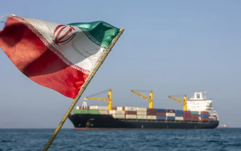 Iranian flag waving in the wind, symbolising the country's historic decision to surrender uranium and open the Strait of Hormuz as part of a landmark deal with the US, marking a significant shift in the nation's behaviour and a major breakthrough in international relations