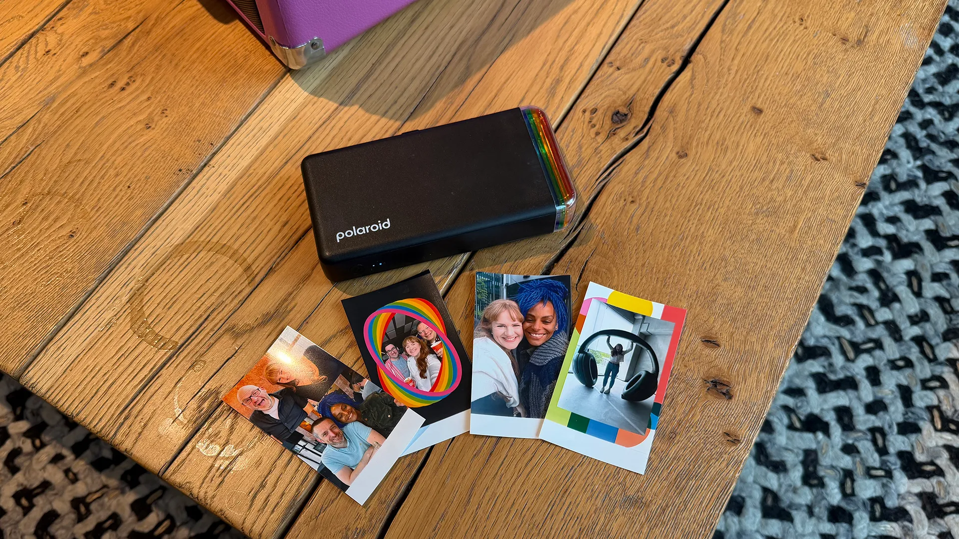 The Polaroid Hi-Print Generation 2 in action, printing out a vibrant photo with a peel-and-stick backing, perfect for instant photography in the UK
