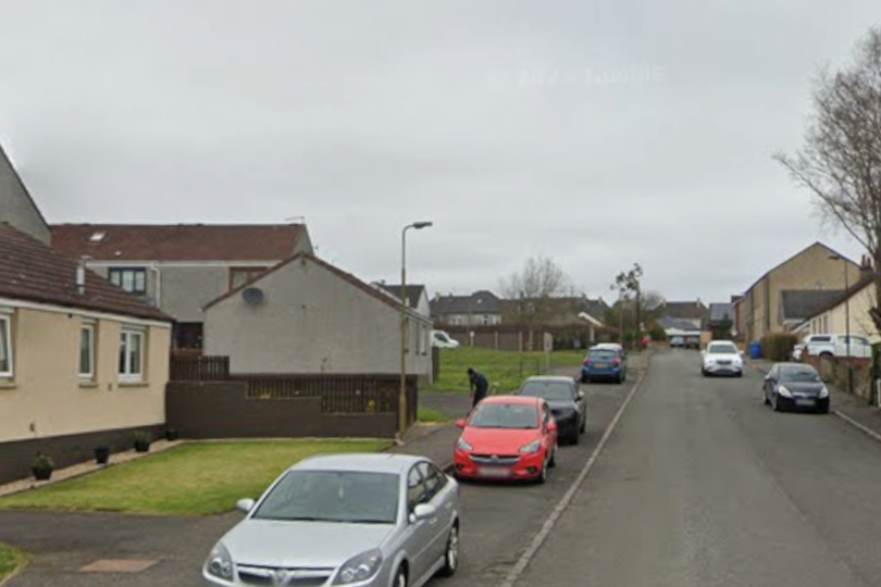 A sombre image of a West Lothian town, with a police car and officers in the foreground, highlighting the tragic incident and ongoing investigation, with a focus on community support and mental health awareness