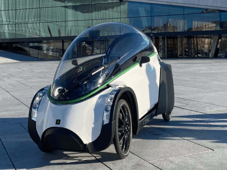 The TwoZero electric vehicle, a licence-free and registration-free car alternative, navigating through city streets with ease, providing a convenient and sustainable mode of transportation