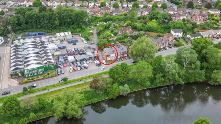 A stunning Victorian home with riverside views, featuring sash windows and a charming façade, surrounded by lush greenery and a tranquil atmosphere, perfect for those seeking a peaceful retreat, with a huge catch that it requires extensive renovation