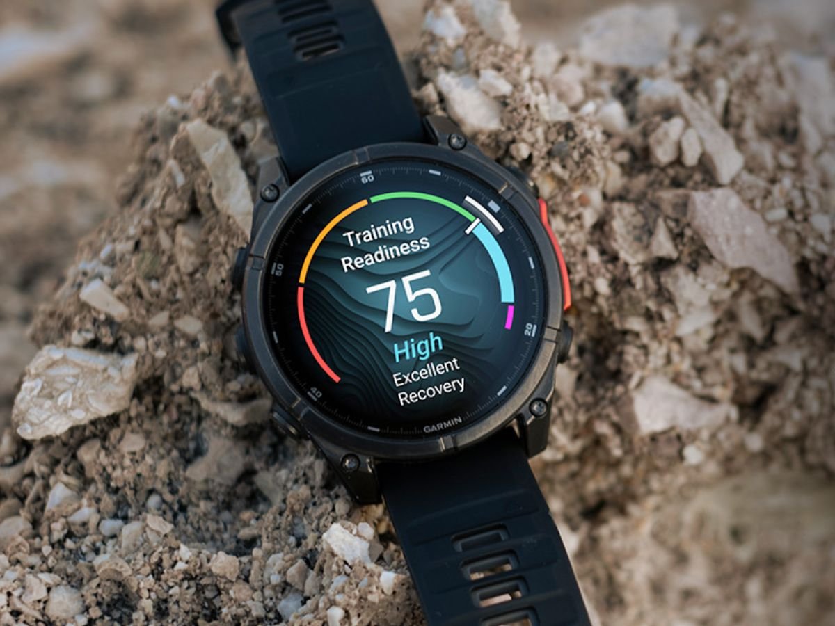 Garmin smartwatch with a green strap, displaying the Heart Rate Variability feature on its screen, with a person running in the background, showcasing the device's ability to track daily stress and overall well-being, highlighting the importance of accurate HRV readings in a smartwatch.