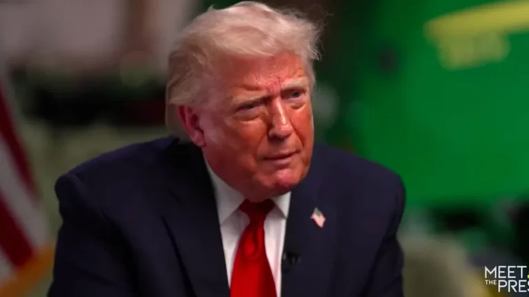 President Trump speaking at a press conference, surrounded by reporters and camera crews, with a serious expression, discussing his stance on military intervention and foreign policy, which has been a subject of controversy and debate