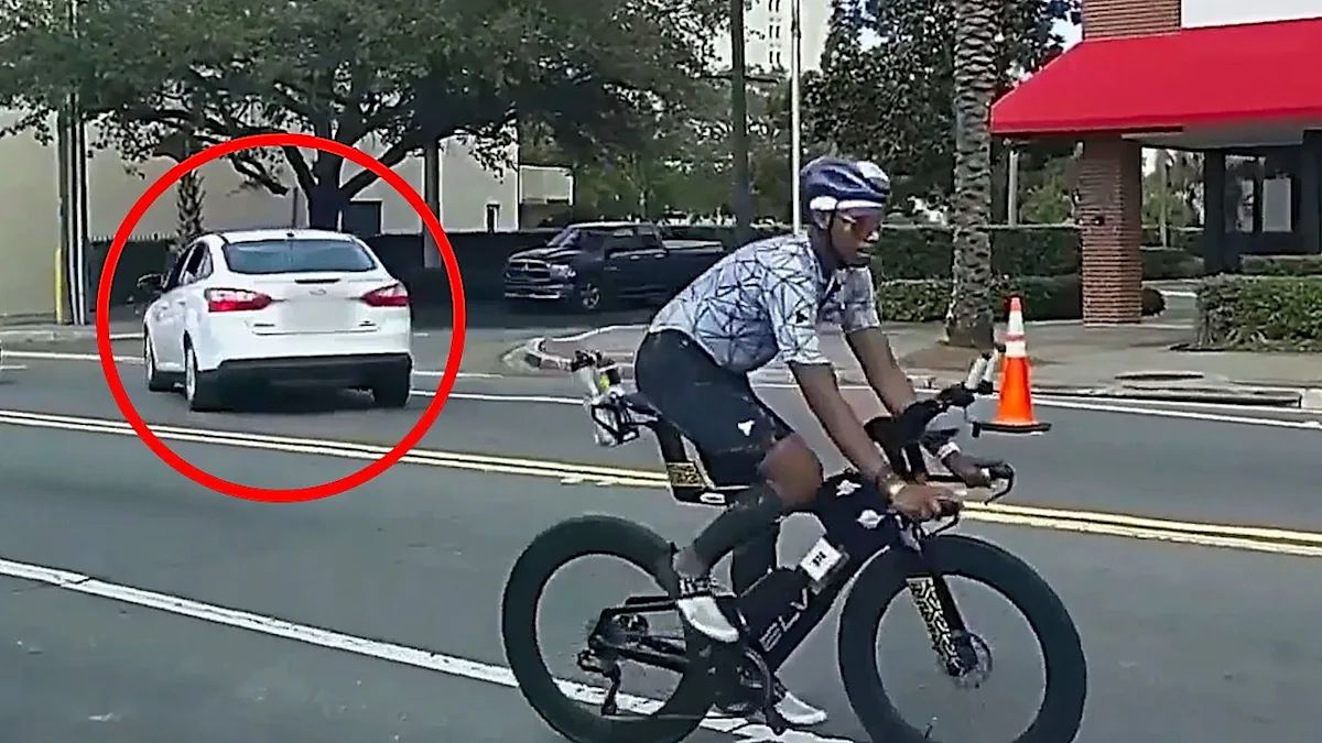 Police car chasing a vehicle through an Ironman race course in Florida, with athletes and spectators looking on in shock, highlighting the primary keyword of Ironman Florida