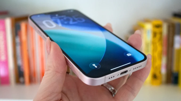 A close-up of an iPhone screen displaying the Apple Intelligence settings, with a blurred background of a person holding the phone, highlighting the focus on privacy and user control in the UK