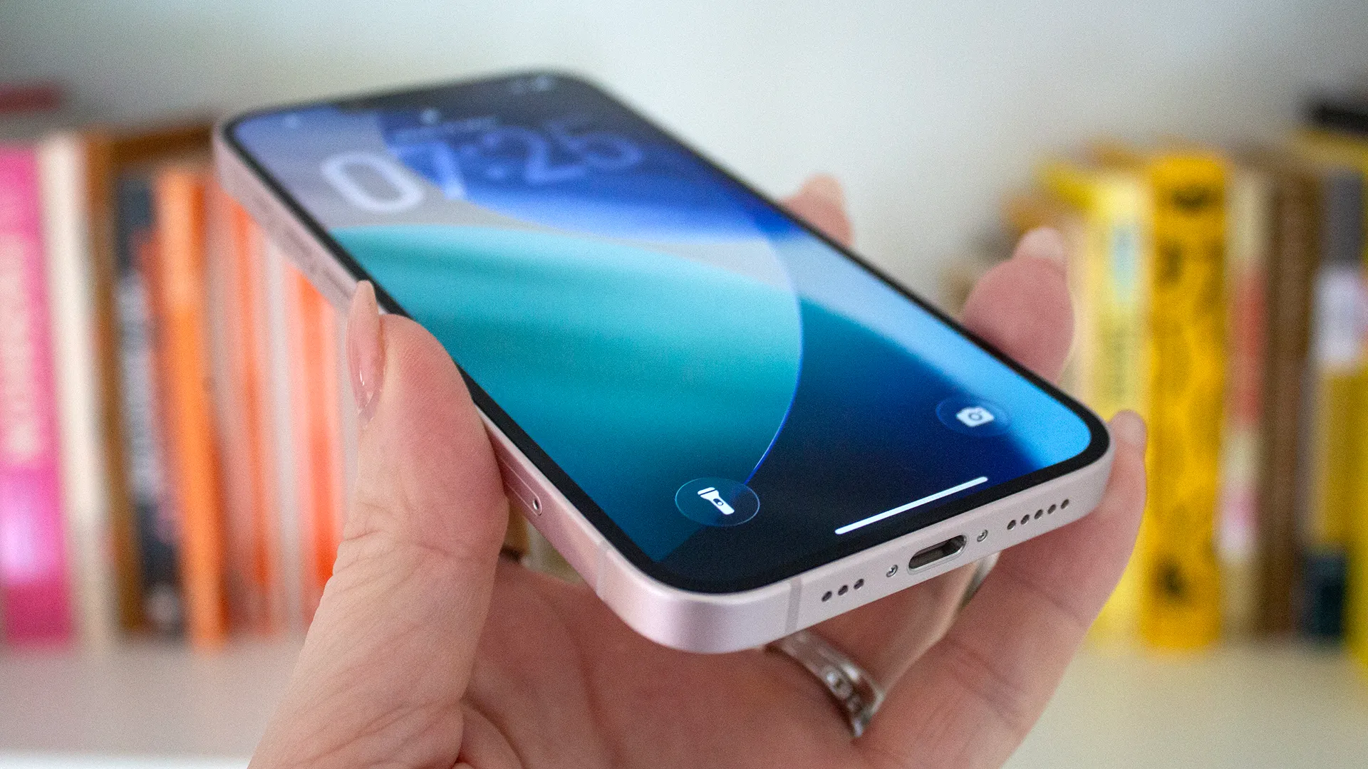 A close-up of an iPhone screen displaying the Apple Intelligence settings, with a blurred background of a person holding the phone, highlighting the focus on privacy and user control in the UK