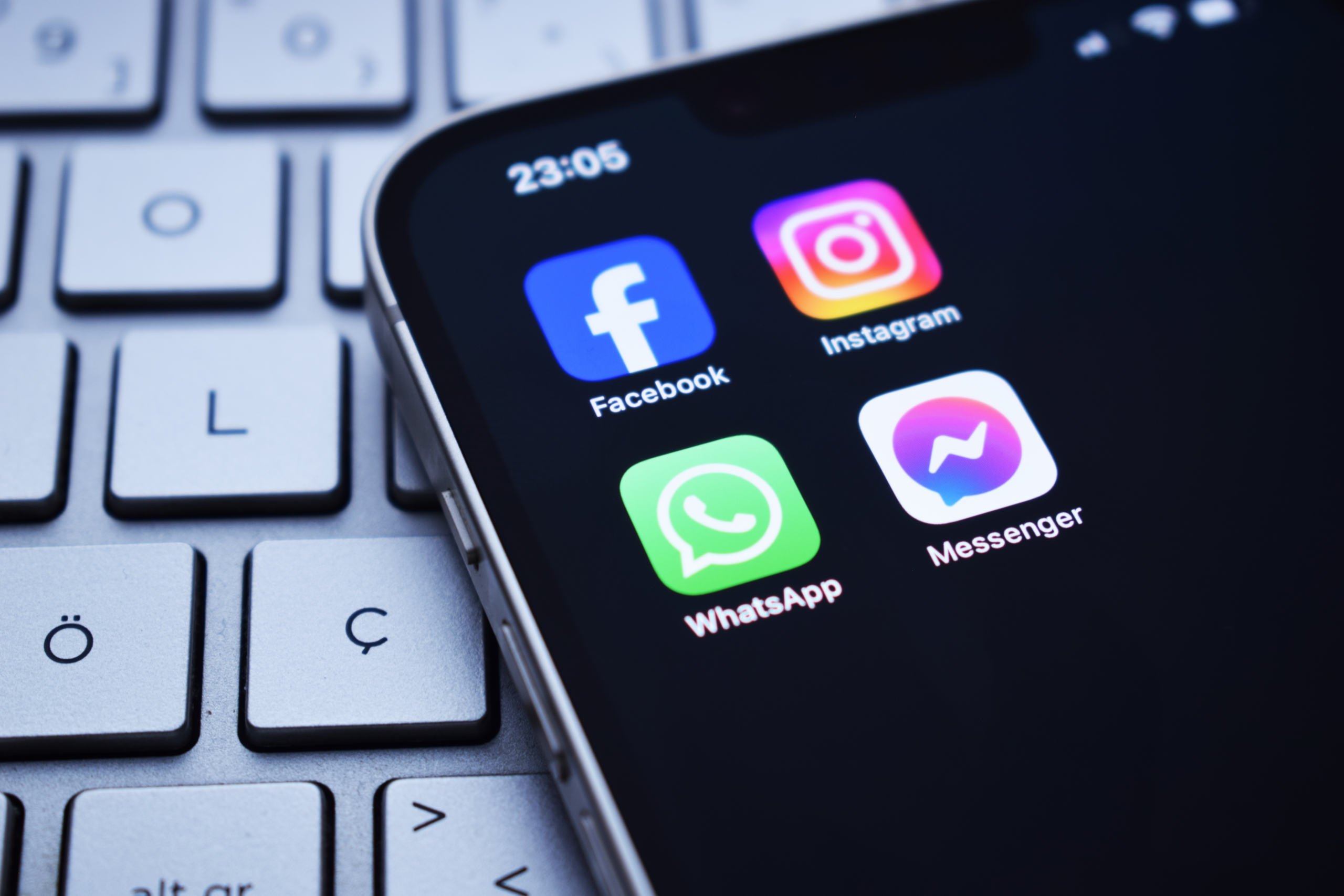 UK Introduces Social Media Ban for Under-16s: What You Need to Know 1 A group of children playing together outdoors, with a few mobile phones and tablets visible in the background, highlighting the UK's social media ban for under-16s and the importance of online safety and responsible technology use.