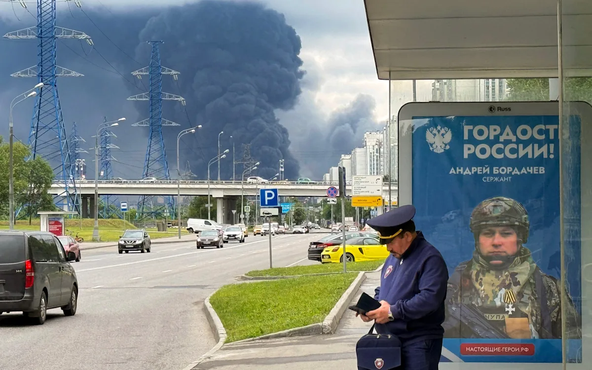 Aerial view of the Moscow oil refinery after the Ukrainian attack, with smoke billowing from the damaged facility, highlighting the devastating impact of the conflict on Russia's energy infrastructure and the global oil market