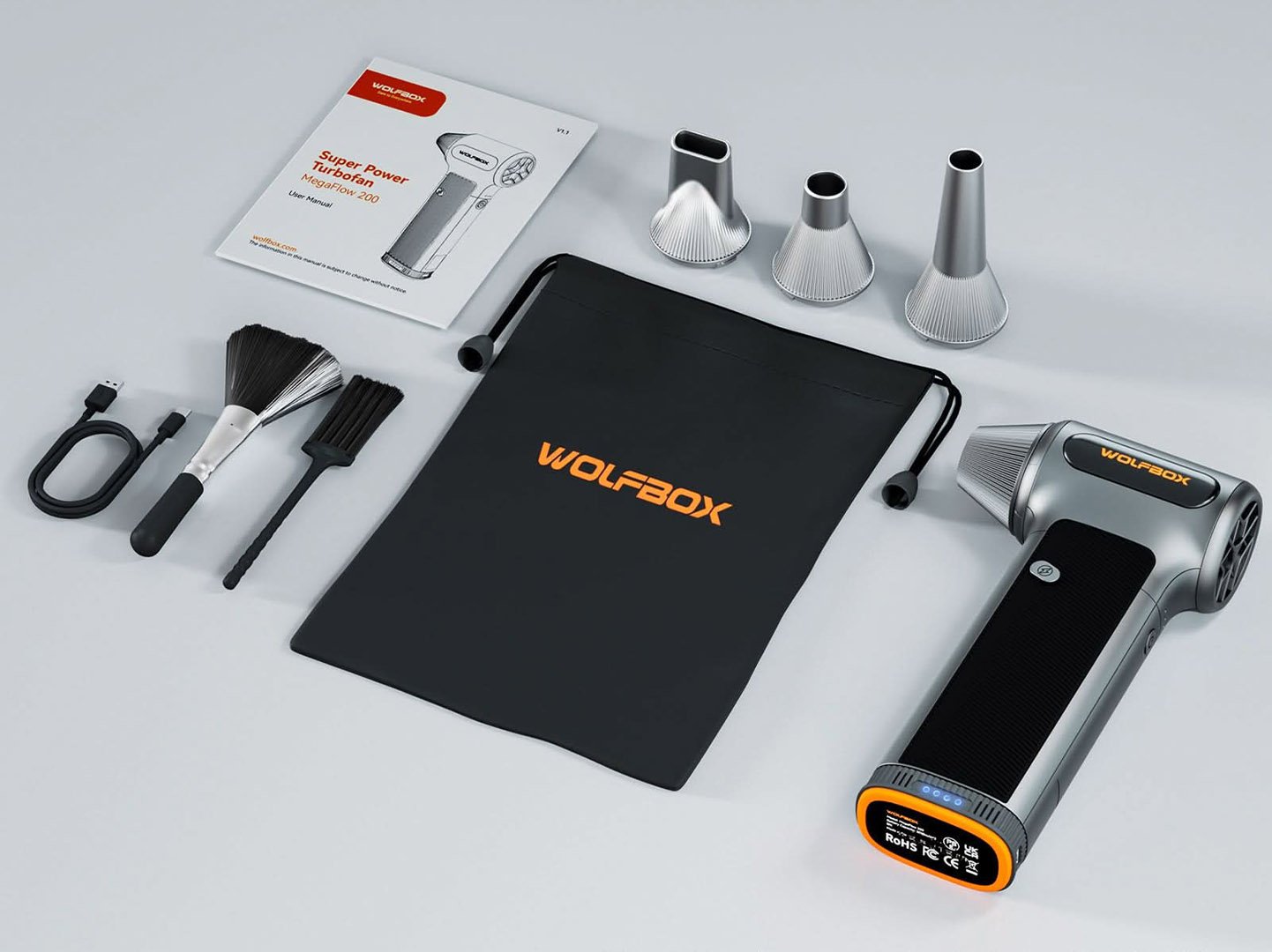 The WOLFBOX MF200 portable air blower in action, effortlessly removing dust and particles from electronic devices with its versatile attachments and powerful performance, ensuring your expensive belongings remain clean and functional