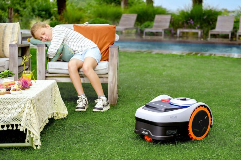The Segway Navimow i2 AWD robotic lawn mower in action, showcasing its boundary wire free navigation and precise turning system, set amidst a beautifully manicured lawn with vibrant green grass and colourful flowers, highlighting the primary keyword robotic lawn mowers