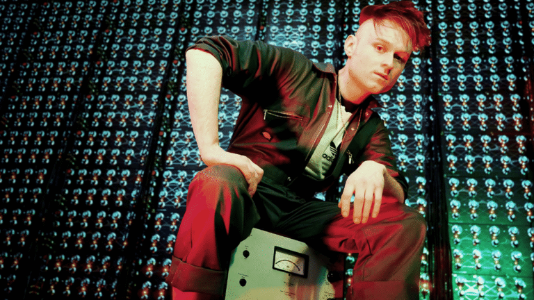 Look Mum No Computer, the experimental singer and YouTuber chosen to represent the UK at Eurovision 2026, posing with their signature equipment, showcasing their colourful and quirky behaviour, ready to analyse and captivating the audience with their music