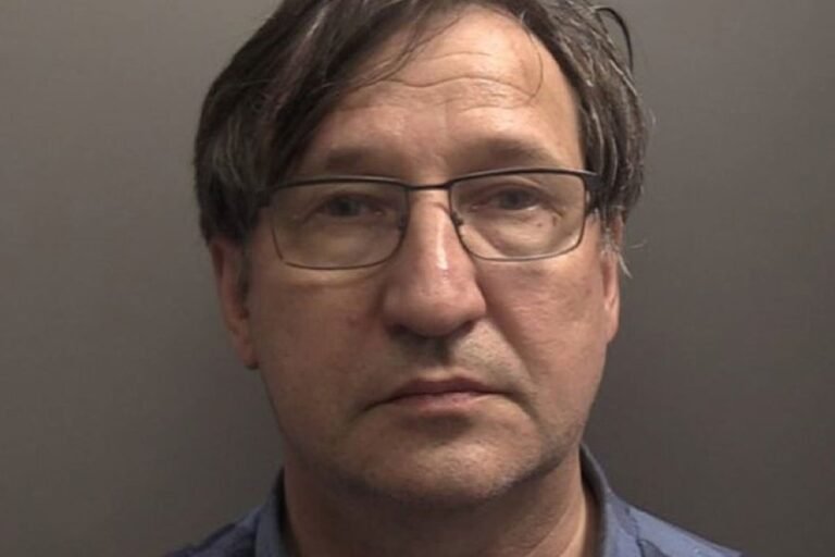 A ship sailing through rough seas off the Yorkshire coast, with a dramatic sky and waves crashing against the shore, highlighting the importance of maritime safety and the risks of ship collisions