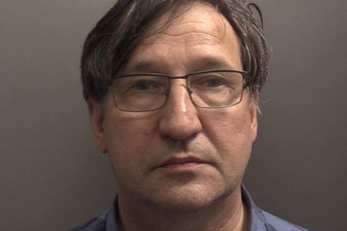 A ship sailing through rough seas off the Yorkshire coast, with a dramatic sky and waves crashing against the shore, highlighting the importance of maritime safety and the risks of ship collisions
