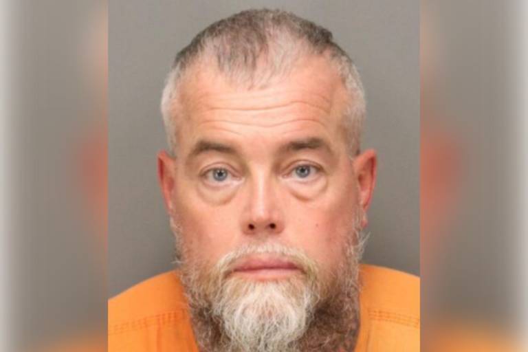 A man holding a giant cheque with a mixture of shock and disappointment on his face, symbolising the downfall of a Powerball winner who struggled to cope with sudden wealth and ended up being arrested for the second time