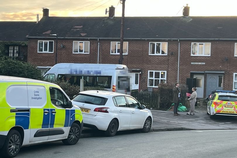 A woman being treated by paramedics after a horrific knife attack, with police officers and forensic experts in the background, investigating the scene and analysing evidence, in an effort to prevent future knife crime and promote community safety