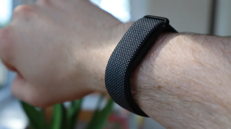 Concept render of Apple screenless fitness band beside Fitbit Air and Whoop Strap