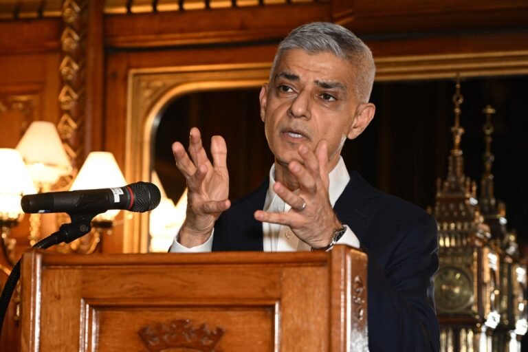 Sadiq Khan speaking at a podium, with a European Union flag in the background, discussing his plans to reverse Brexit and the potential impact on UK-EU relations, with a focus on the future of the UK