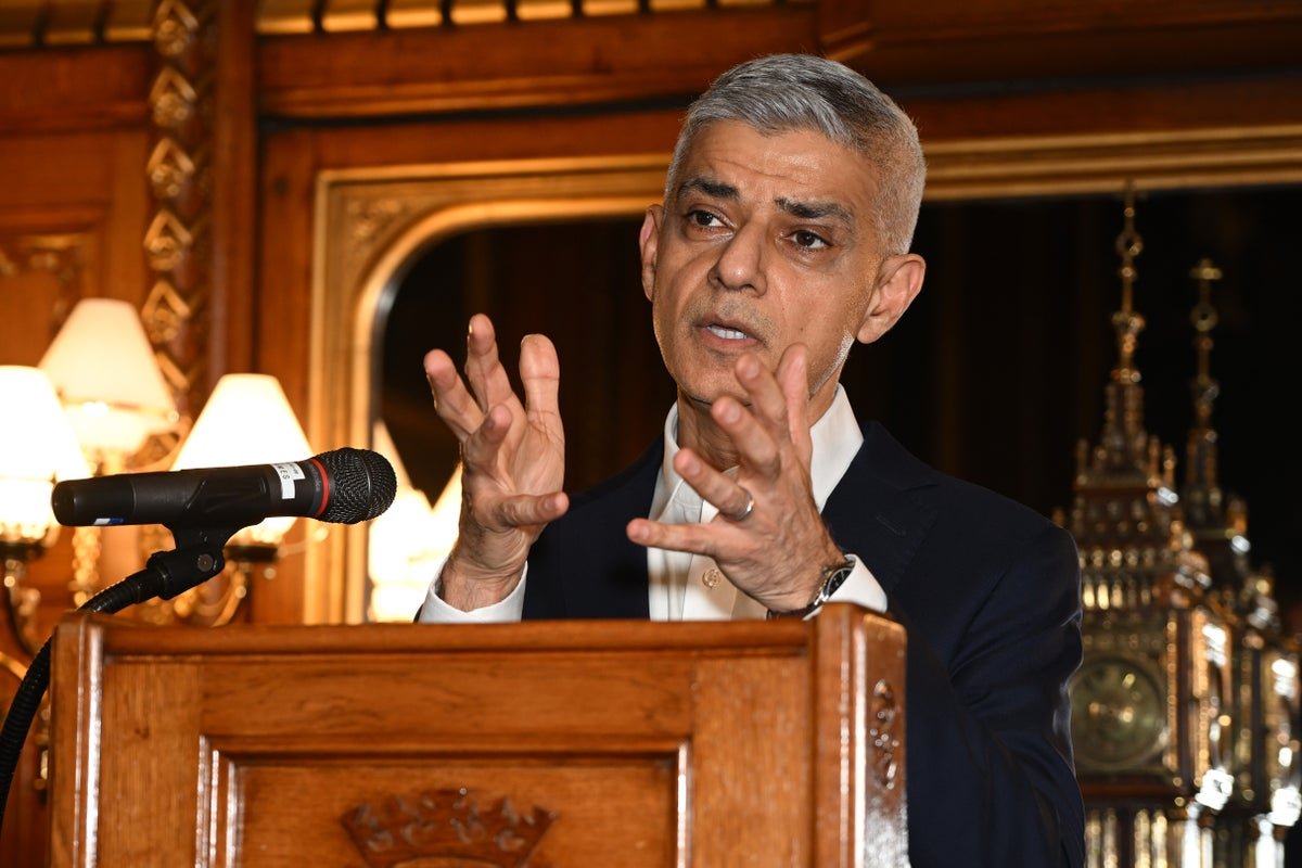 Sadiq Khan speaking at a podium, with a European Union flag in the background, discussing his plans to reverse Brexit and the potential impact on UK-EU relations, with a focus on the future of the UK