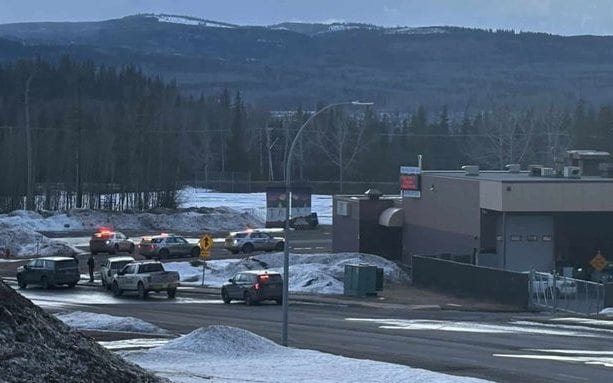 A sombre and respectful image of a school in mourning, with a flag at half-mast, symbolising the tragic loss of life in the recent school shooting, highlighting the need for improved gun control and mental health support