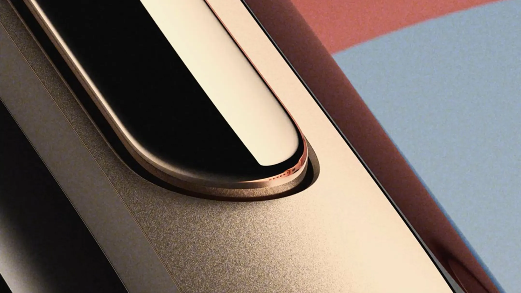 Close‑up of the Google Fitbit Edge wearable in champagne gold with a silicone strap