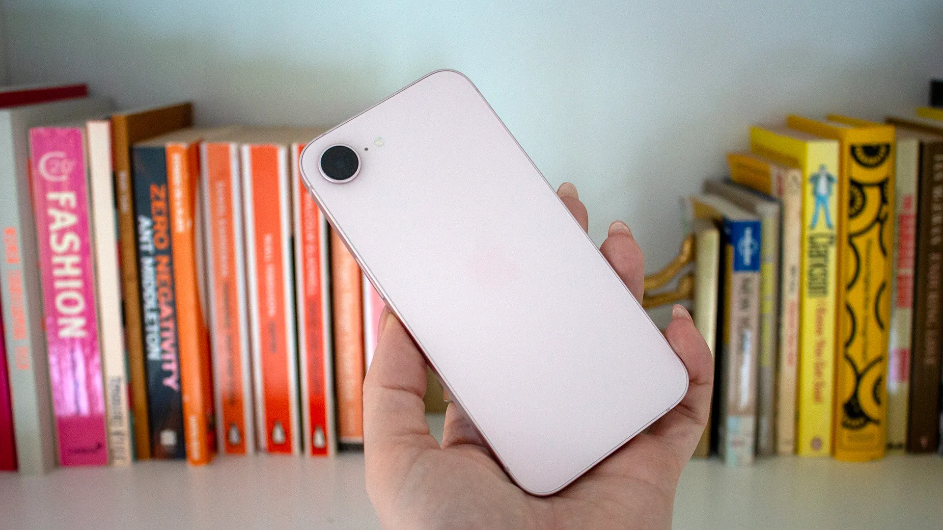 Refurbished Apple iPhone 17e held in hand showing its compact display and ceramic shield