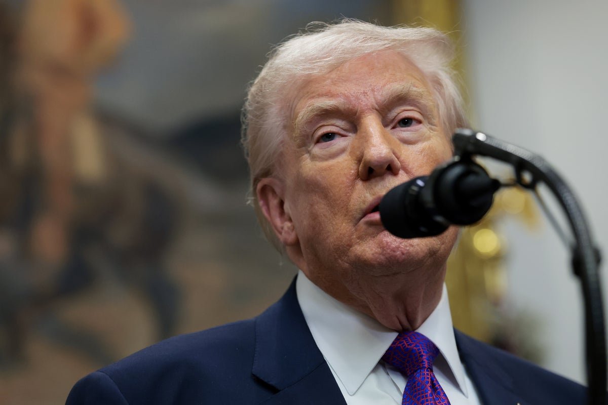 Donald Trump speaking at a podium with a mixture of people in the background, some looking shocked and others looking angry, with a caption that reads 'Trump's comments on the 'Obama ape' video have sparked widespread debate and criticism'